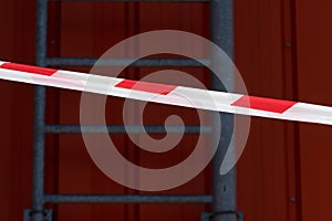 red and white warning caution tape against the background of the fire escape. Danger of fire in the store. An accident on the