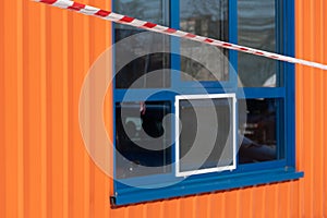 red and white warning caution tape against the background of a market window. Shop robbery. Accident on the territory of paid