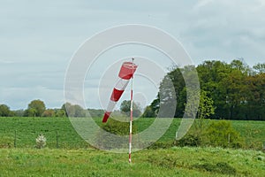 A red and white wind cone indicating the direction and strength of the wind