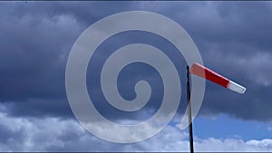 Red and white windbag against a cloudy sky in Bremm Germany