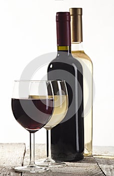 Red and white wine bottles with glasses