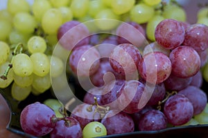 Red and White wine bunch of grapes in the black plate