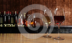 Red and white wine in clear glass, many blurred wine , whisky and brandy bottle backgrounds Place it on a wooden and mable floor