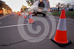 Red and white witches hat cone traffic warning sign barrier applying on busy street downtown on pedestrian footpath