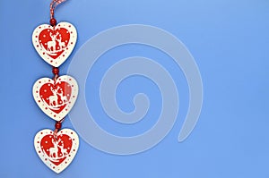 Red and white wooden hearts on a blue-blue background