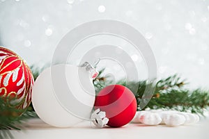 Red and white xmas ornaments on glitter holiday background. Merry christmas card.