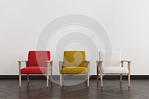 Red, white and yellow armchairs in an empty room