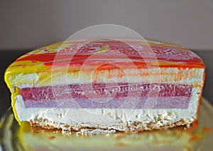Red, white and yellow marbling mirror glaze mousse cake. Homemade slice of cake with leopard mirror glaze. Modern european dessert