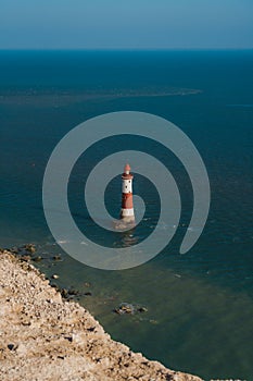 Red and whiteâ€“striped Beachy Head Lighthouse against chalk cliffs,  view from top of Seven Sisters, Clifftop Paths Nature