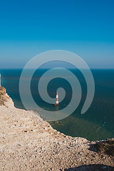 Red and whiteâ€“striped Beachy Head Lighthouse against chalk cliffs,  view from top of Seven Sisters, Clifftop Paths Nature