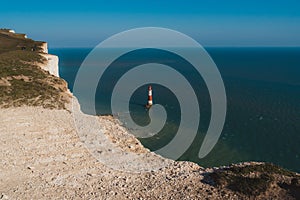 Red and whiteâ€“striped Beachy Head Lighthouse against chalk cliffs,  view from top of Seven Sisters, Clifftop Paths Nature