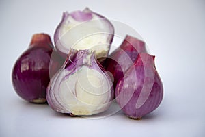 Red whole and sliced onions, isolated on white background