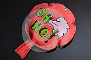 Red whoopee cushion with reflection on black glass