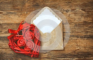 Red wicker heart with roses, envelope with blank note