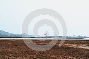 Red wind sock beside runways on small airfield