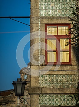 Red window of ancien house with loantern photo