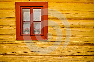 Red window, yellow wall in old house