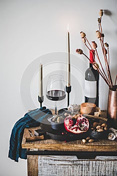 Red wine and appetizers over rustic wooden kitchen counter