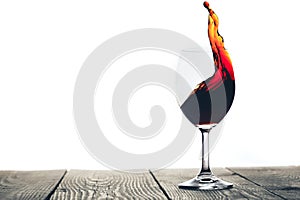A red wine being poured into a glass on a white background
