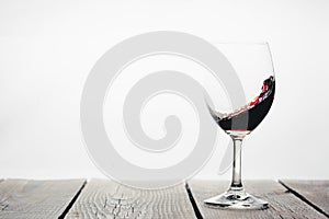 A red wine being poured into a glass on a white background