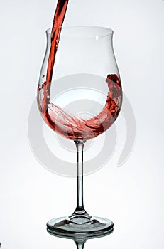 Red wine being poured into a wine glass