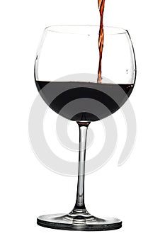 Red wine being poured into wine glass on white background