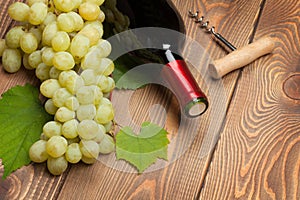 Red wine bottle and bunch of white grapes