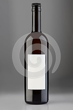 Red wine bottle with cap and blank label on gray background