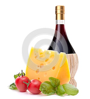 Red wine bottle, cheese and tomato still life