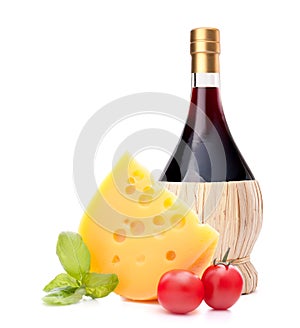 Red wine bottle, cheese and tomato still life