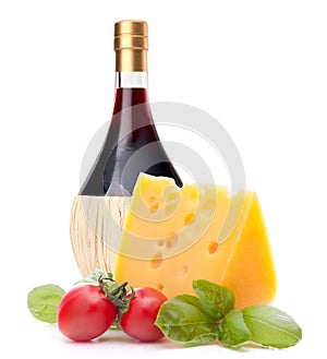 Red wine bottle, cheese and tomato still life