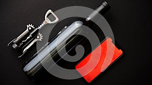 Red wine bottle, corkscrew and boxed christmas gift