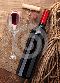 Red wine bottle, glass, cork and corkscrew. View from above