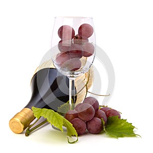 Red wine bottle and glass full with grapes