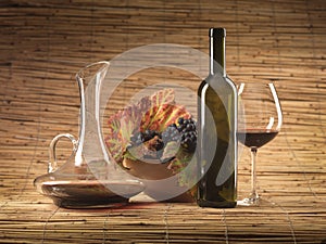 Red wine bottle, glass, grapes, decanter rustic