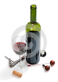 Red wine bottle, glasses, corkscrew, corks and thermometer.