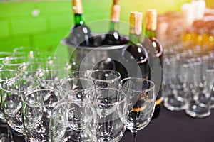 Red wine bottle in ice bucket and wine glass on the table background / champagne glass for celebration party