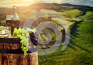 Red wine bottle and wine glass on wodden barrel