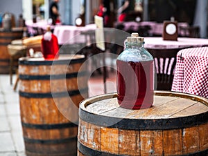 Red wine bottle and wooden barrel