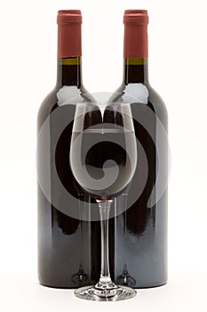 Red wine bottles with filled wineglass