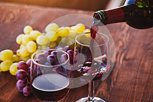 red wine closeup, pouring from bottle to glass