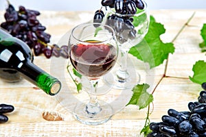 Red wine concept with bottle, glass and grapes