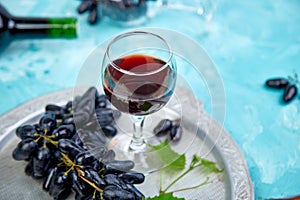 Red wine concept with bottle, glass and grapes