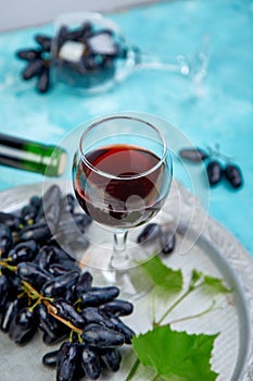 Red wine concept with bottle, glass and grapes