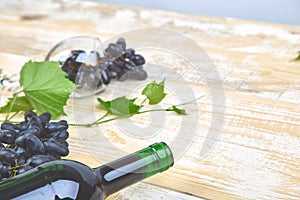 Red wine concept with bottle, glass and grapes