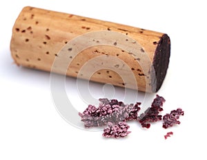 red wine cork and dry crystallized wine sediment on a white background