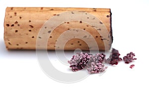 red wine cork and dry crystallized wine sediment on a white background