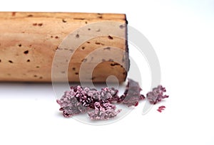 red wine cork and dry crystallized wine sediment on a white background