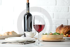Red wine and delicious dinner served on light table
