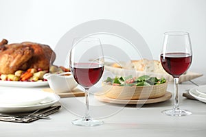 Red wine and delicious dinner served on light table